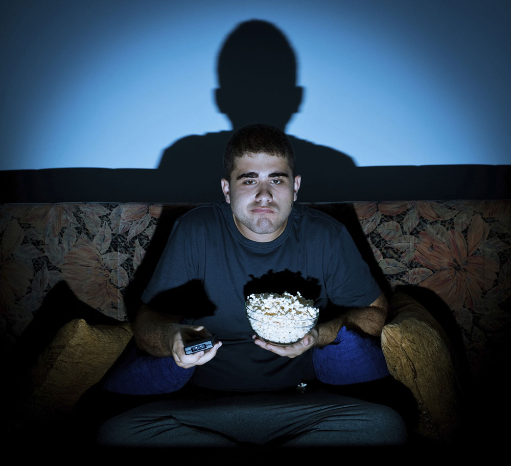 man-watching-tv-bored-eating